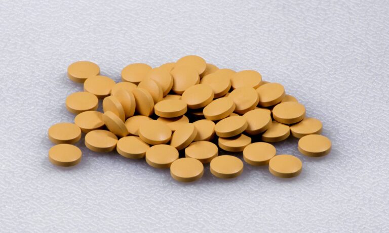 Generic cyclobenzaprine pills on a white surface.