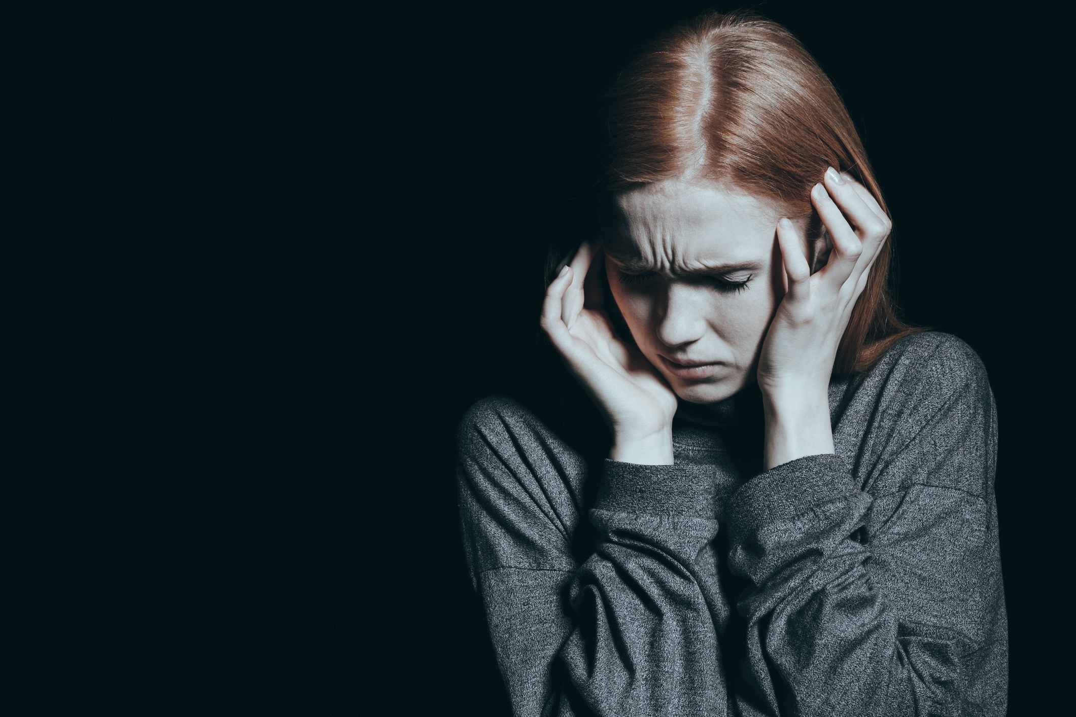 Fearful woman covering her ears